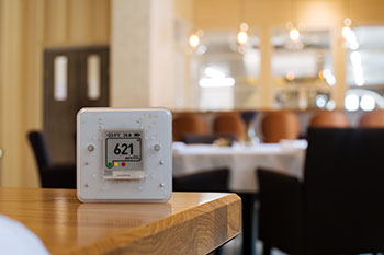 Air quality sensor in an indoor room on a table displays 621 ppm CO2